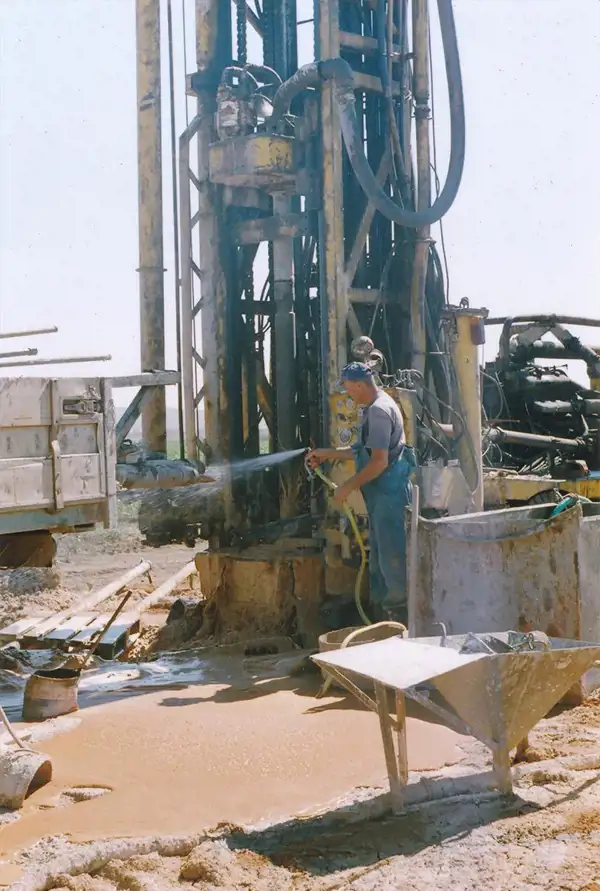Operator washing down the drilling rig on site